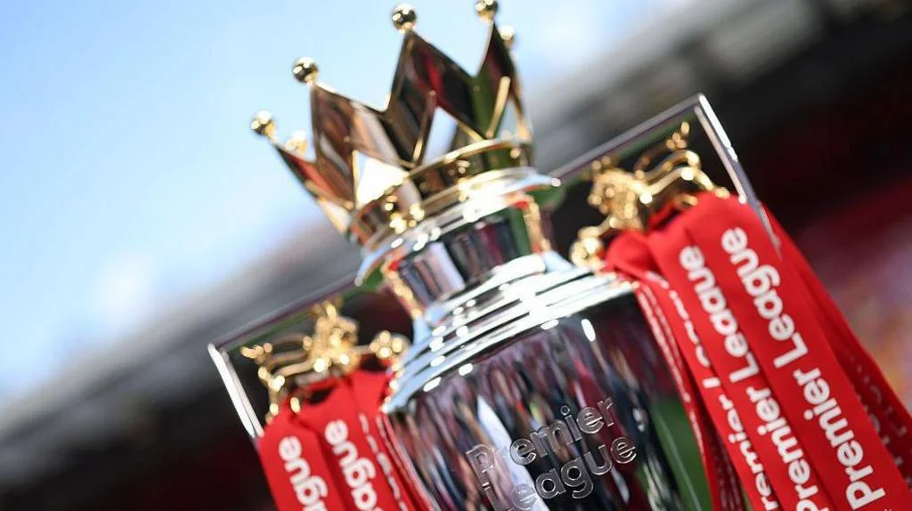 The Premier League trophy with red ribbons