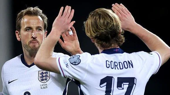 Harry Kane celebrates scoring England's second goal against Latvia with Anthony Gordon in October 2025.