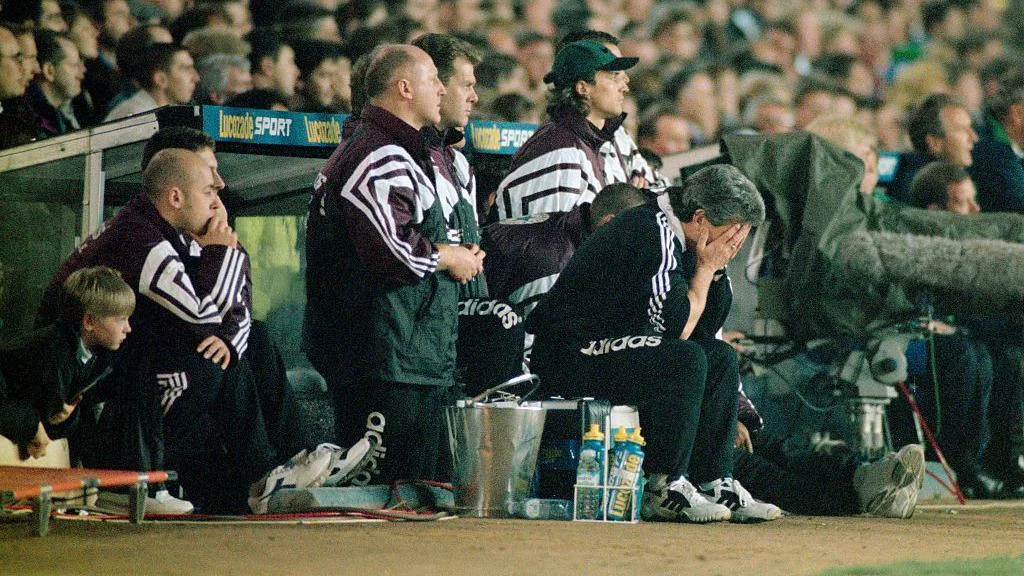 Kevin Keegan, with his head in his hands, sits in front of the rest of Newcastle's bench